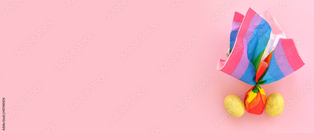 Colorful Easter eggs on a pink background in a the style of minimalism. with place for text. Easter background with lights. layout concept for lgbt