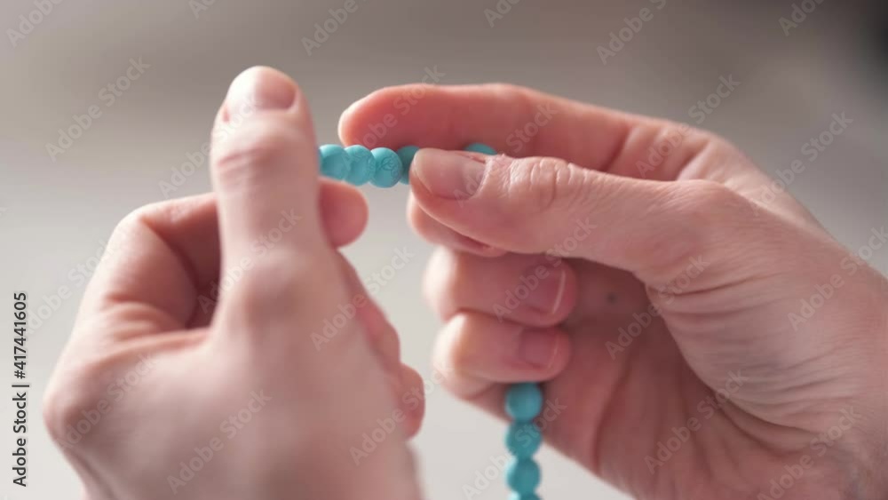 Close Up Shot of Muslim Woman Hands. Praying with Rosary in Mosque Under Daylight. High Angle View. Close Up Shot of Muslim Woman Hands. Praying with Rosary in Mosque Under Daylight. High Angle View.