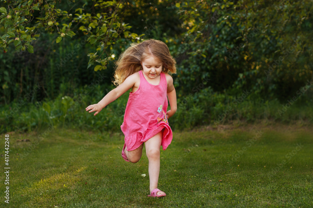 happy baby smiling. little girl running at a sunset outdoor happy baby smiling. little girl running at a sunset outdoor