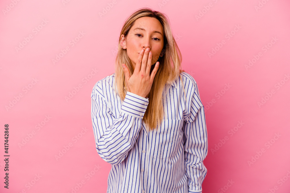 Young mixed race woman isolated on pink background shocked, covering mouth with hands, anxious to discover something new. Young mixed race woman isolated on pink background shocked, covering mouth with hands, anxious to discover something new.