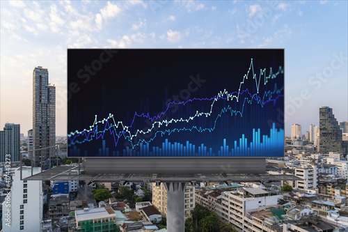 Glowing FOREX graph hologram on billboard, aerial panoramic cityscape of Bangkok at sunset. Stock and bond trading in Southeast Asia. The concept of fund management.