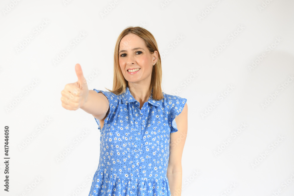Smiling pretty young woman showing thumb up isolated over white background Smiling pretty young woman showing thumb up isolated over white background