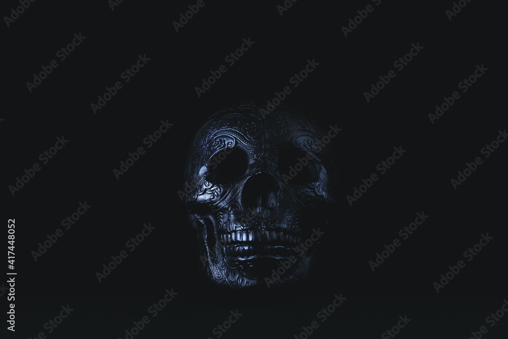 Black skull on black background with ornate decorative details for halloween prop