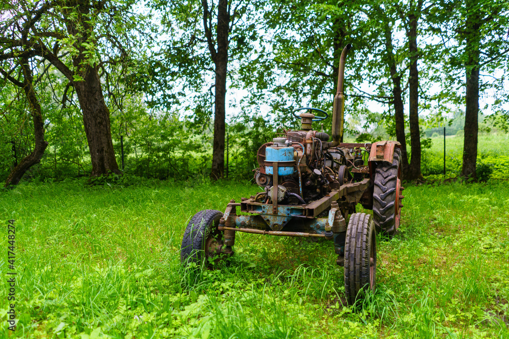 old broken tractor in the field old broken tractor in the field