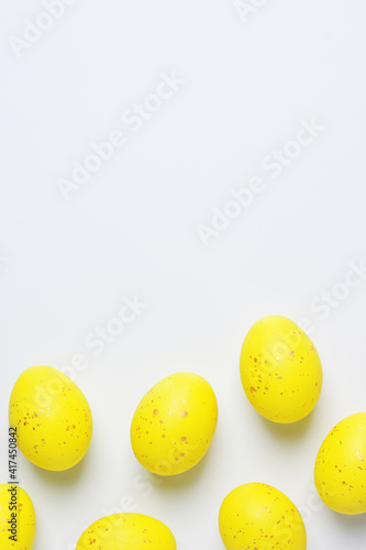 Easter yellow eggs on a white background. Flat lay, copy space.