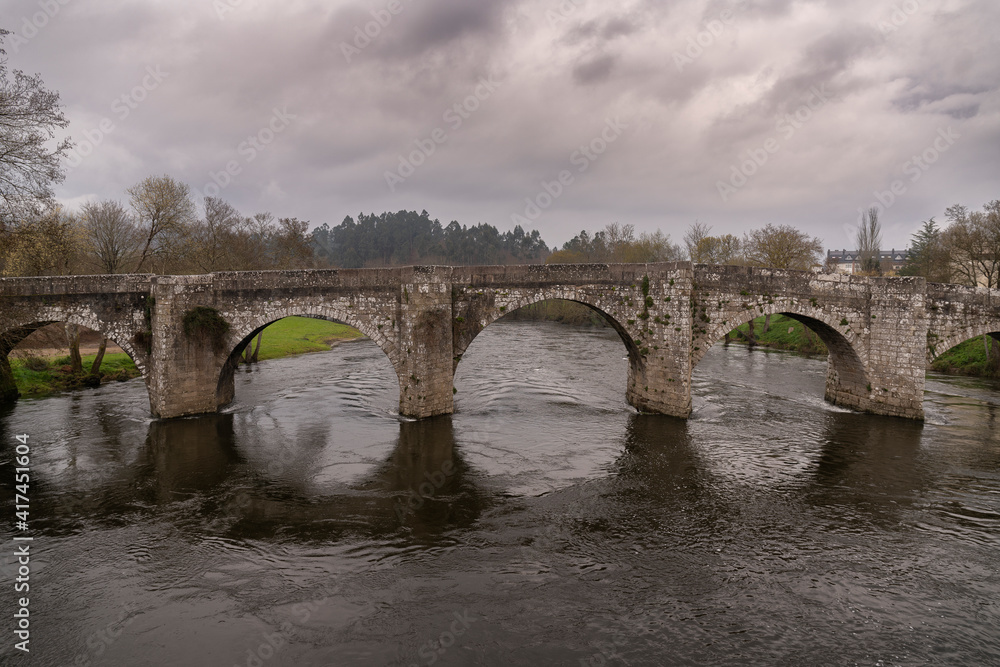 Fototapeta premium Medieval bridge (but of Roman origin) of Pontevea. In Teo, Galicia, Spain. The Roman road XIX passed through this place.