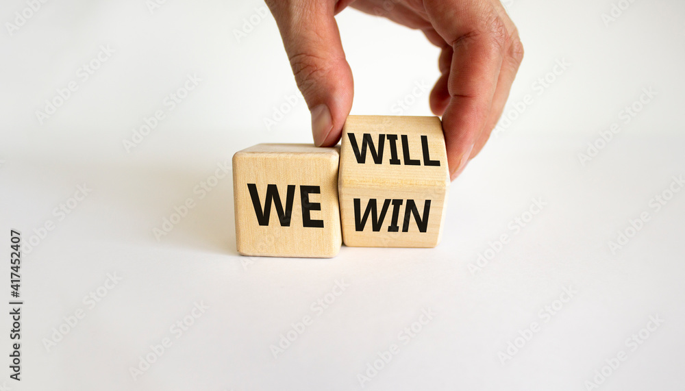 We will win symbol. Businessman turns cubes and changes words we will ...