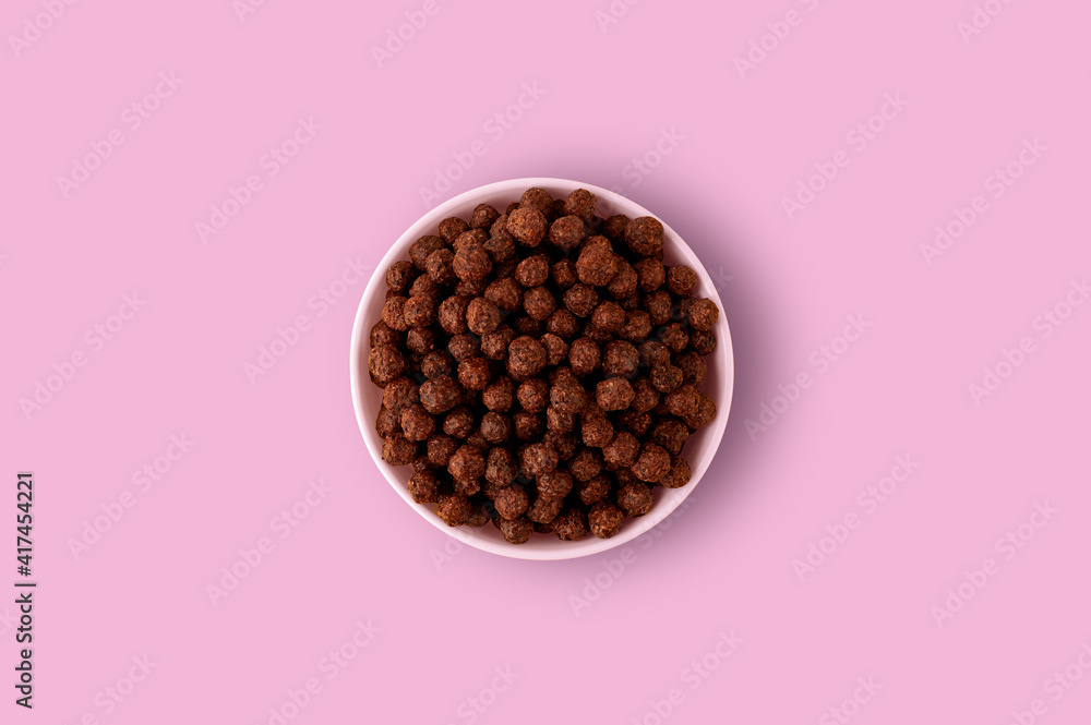 chocolate balls for breakfast in a plate on a pink background