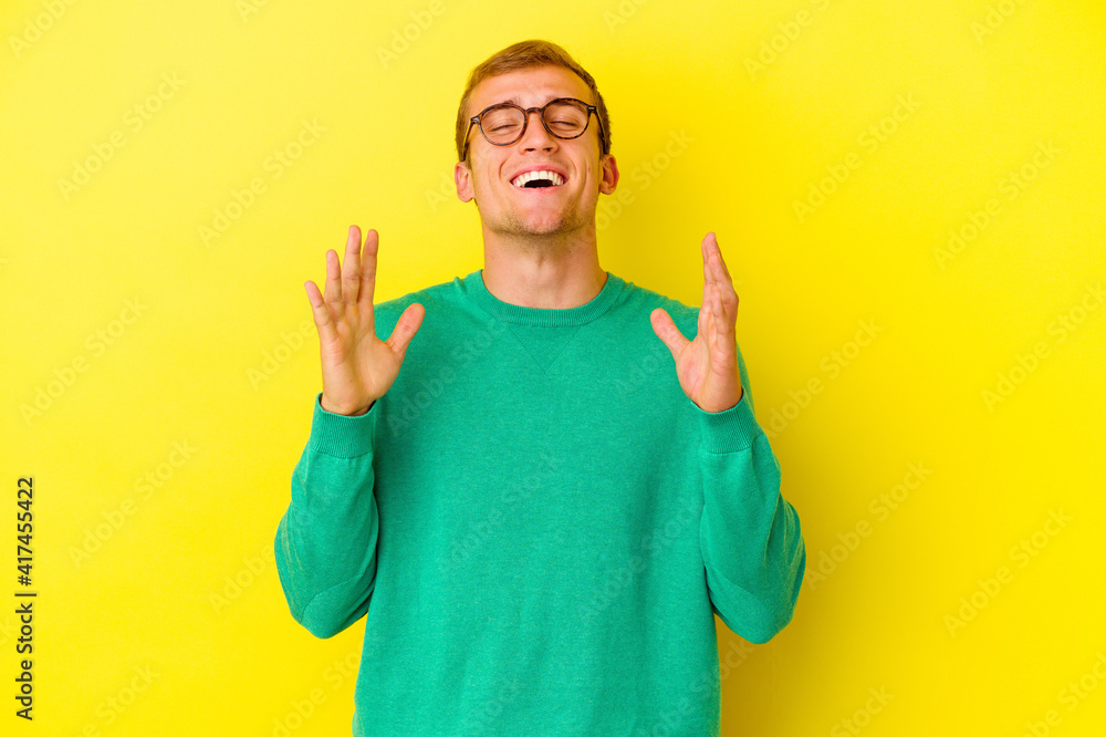 Young caucasian man isolated on yellow background Young caucasian man isolated on yellow background