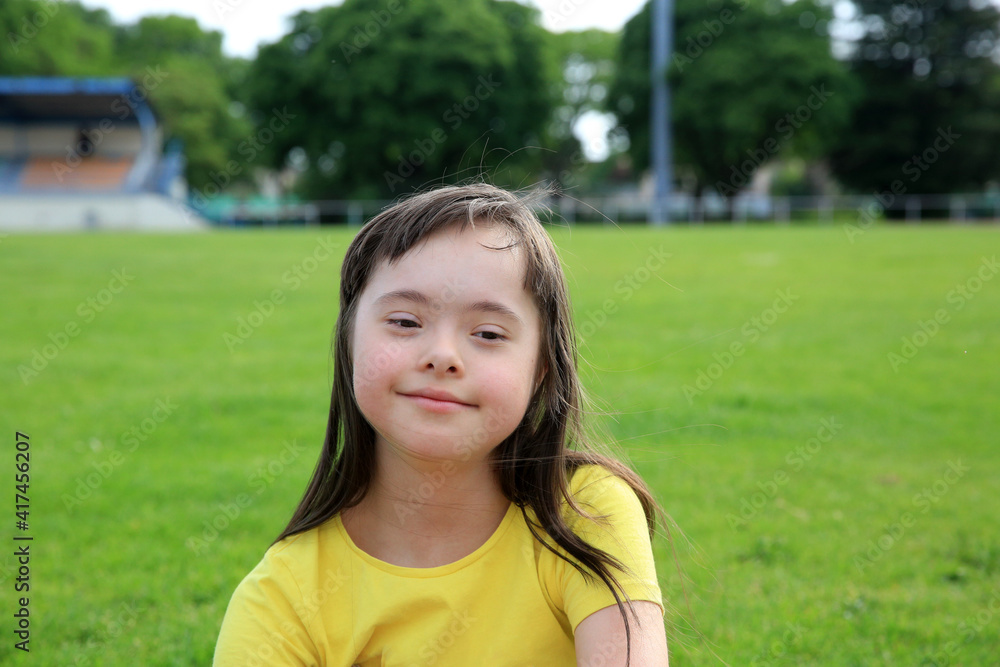 Young girl on the background of green grass of the stadium Young girl on the background of green grass of the stadium