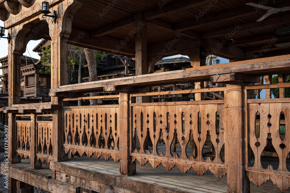 Wooden carved railing of a large wooden house.