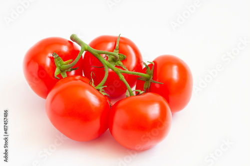Tomatoes on a branch, isolated on a white background © Екатерина Хныкина