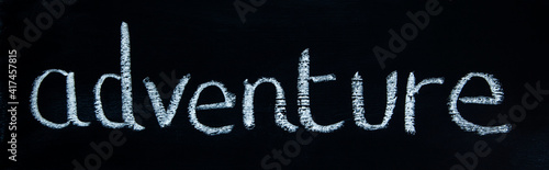 Adventure - in white chalk on a blackboard - panorama for design concepts, inspiration & ideas.