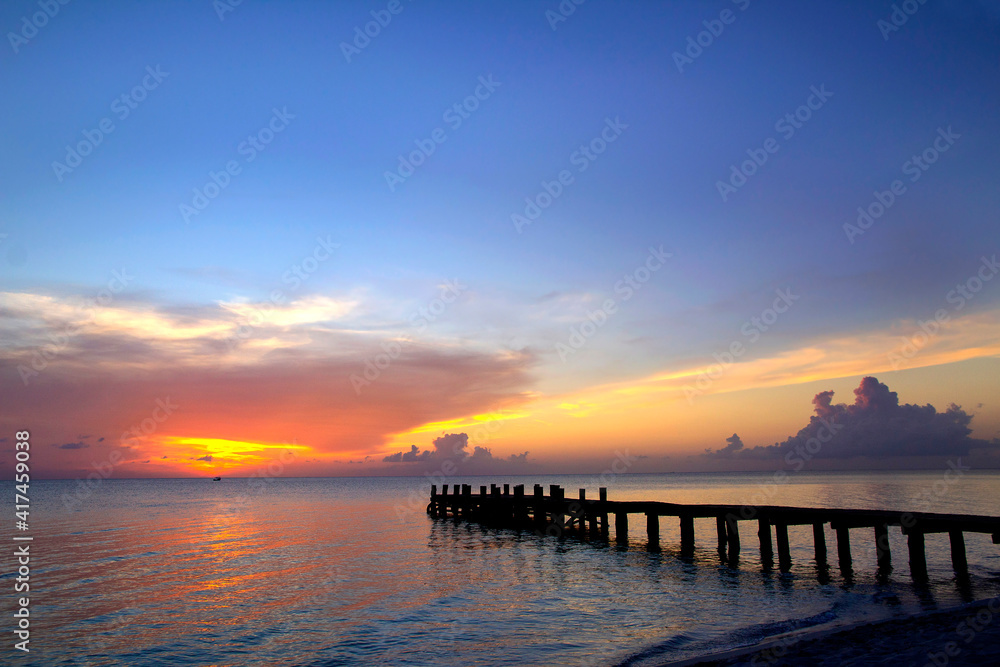 Nice pier with amazing colorful sunset background at Caribbean Sea