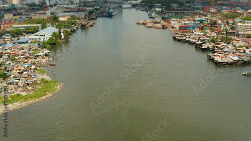 Slum area in Manila, Phillippines, top view. lot of garbage in the water. © Alex Traveler