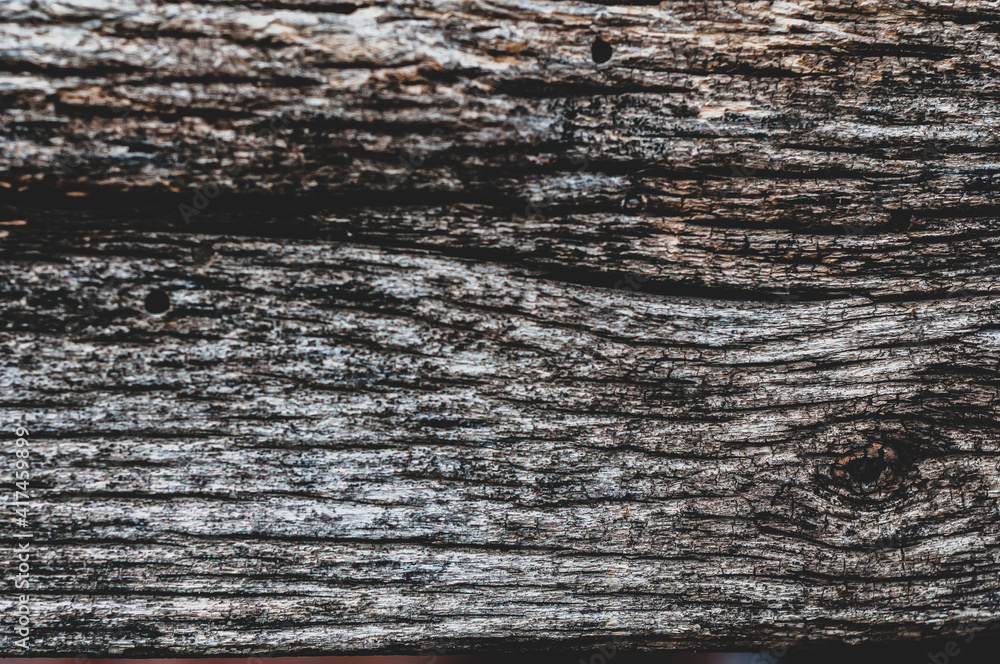 Fototapeta premium Very old cracked wood plank, vintage wood background close-up, rough textured surface