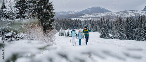 Canvas Print Family with small daughter on a walk outdoors in winter nature, Tatra mountains Slovakia