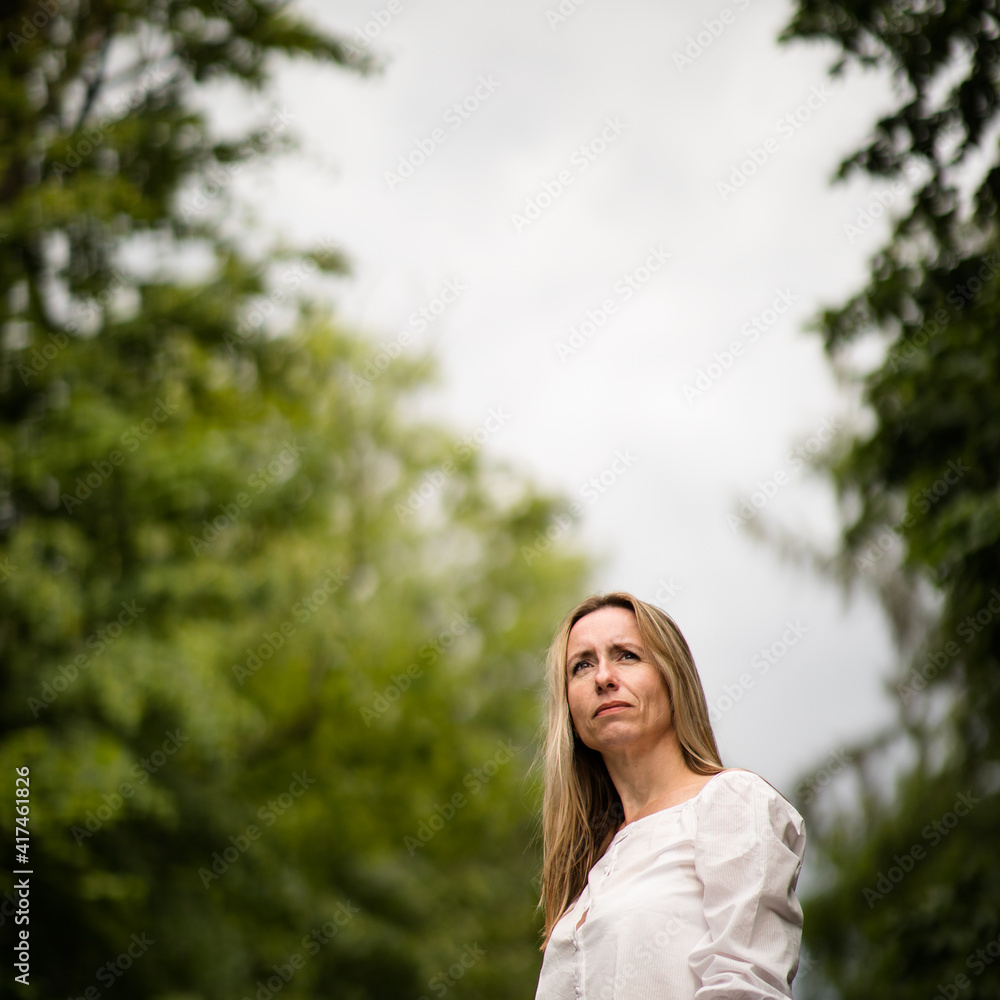 Portrait of a relaxed middle aged woman outdoors, looking happy, enjoying the life Portrait of a relaxed middle aged woman outdoors, looking happy, enjoying the life