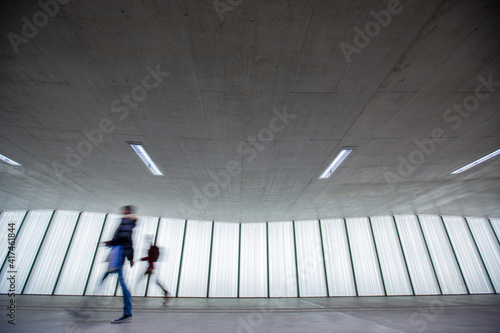 Motion blurred people - figures in an underpassage getting to their workplace in the morning. Busy city business life. photo