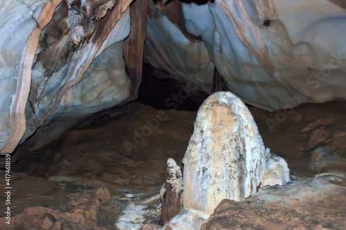 Cave washed in rock, chute. There is delve with access to day surface. Speleological trip. Laos photo