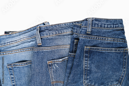 Various blue jeans isolated on white. Beauty and fashion, clothing concept. Detail of nice blue jeans, top view