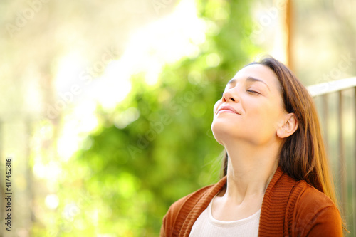 Relaxed woman breathing fresh air in a garden