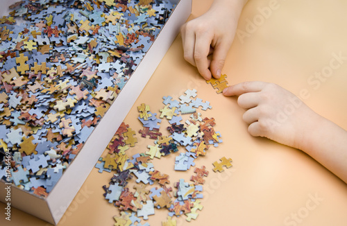 the child collects colorful puzzles on the table