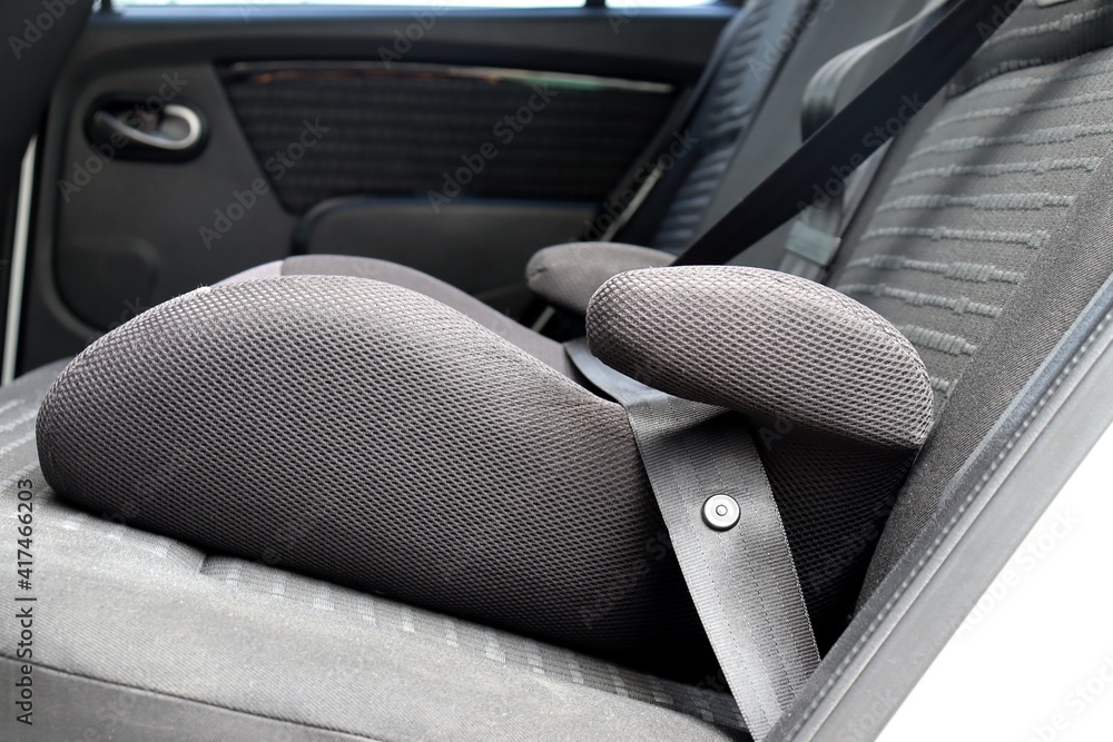 Safety booster seat for children. Car interior.
