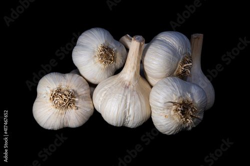 Pile of garlic on a black background. Photo with shallow depth of field.
