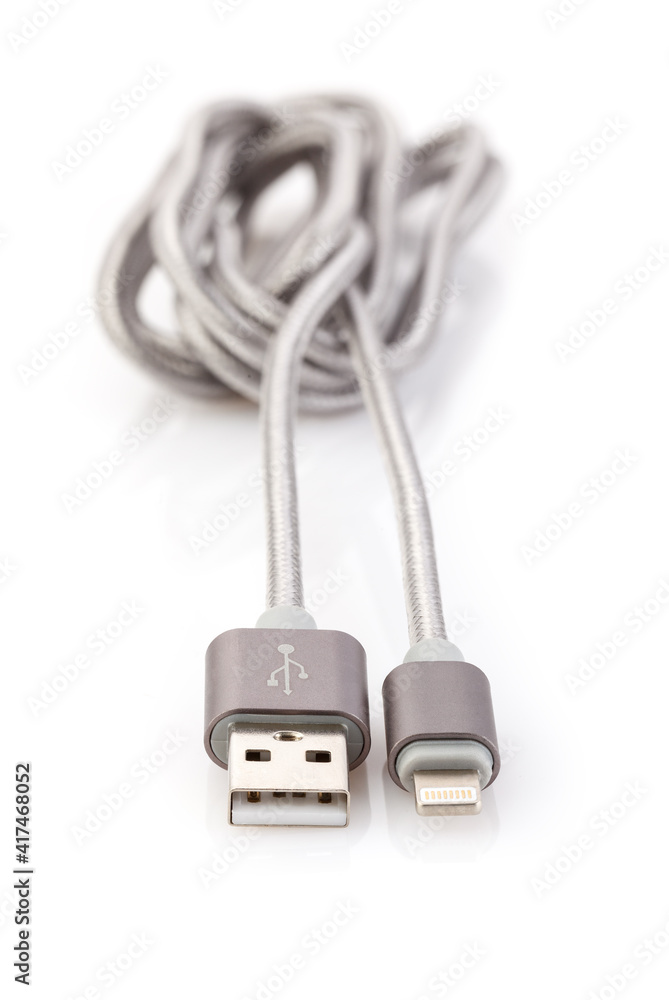 Silver-gray cable USB-Lightning for Data & Power isolated on White Background. Closeup Silver-gray cable USB-Lightning for Data & Power isolated on White Background. Closeup