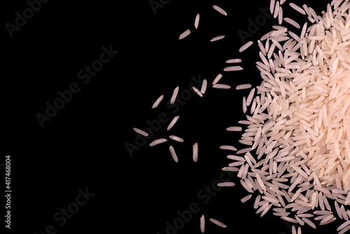 Heap of white rice isolated on black background. rice close-up.