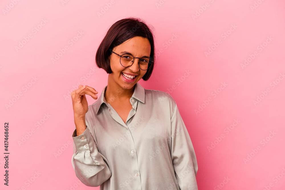 Young mixed race woman isolated on pink background laughing about something, covering mouth with hands. Young mixed race woman isolated on pink background laughing about something, covering mouth with hands.
