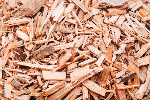 Small pile of wood chips background, top view. Waste from the woodworking industry, fuel and raw materials for heating solid fuel industrial boilers on wood chips photo