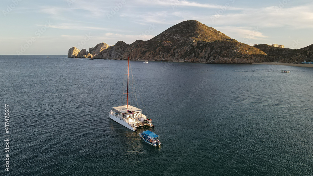  Panoramic view boat on the background of mountains and calm evening water.