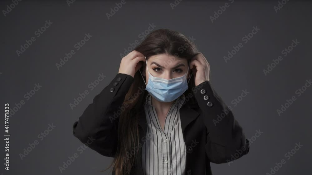 Young businesswoman putting her mask on Young businesswoman putting her mask on