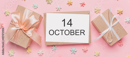 Gifts with note letter on isolated pink background with sweets, love and valentine concept with text 14 October