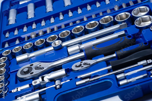 professional set of ratchets and sockets with tool steel bits with added vanadium and chrome on a white background. A set of tools in a portable plastic case photo