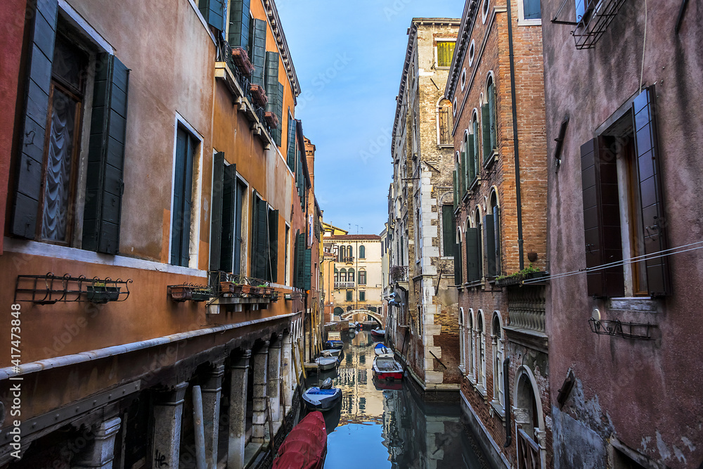 View of old traditional buildings located near the canal. Venice, Italy.