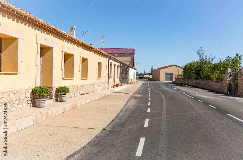 a paved road going through Zayas de Bascones village (Alcubilla de Avellaneda), province of Soria, Castile and Leon, Spain