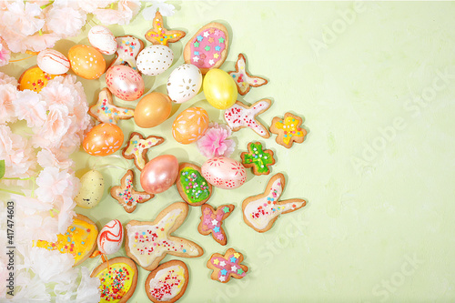 Festive Easter background, spring card, composition with flowers, cookies and eggs on a gentle background. Festive minimal concept, home baking ideas, place for text, banner for screen