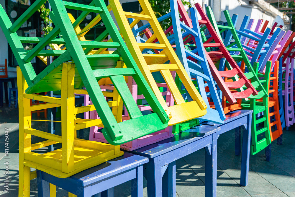 Colored chairs composed in non-working period, a street outdoor cafe in the Turkish city of Kas