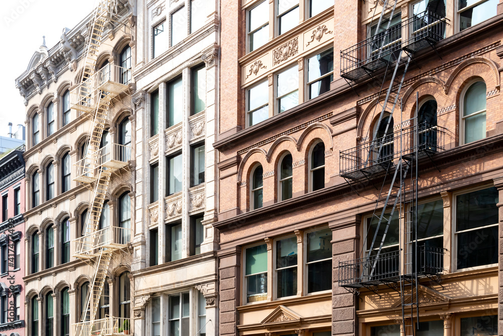 Block of old historic buildings with windows and fire escapes in the SoHo neighborhood  of Manhattan New York City