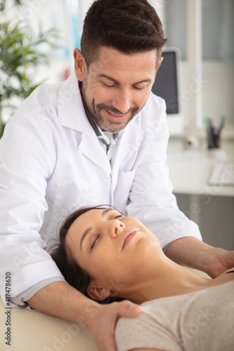 relaxed woman receiving back massage