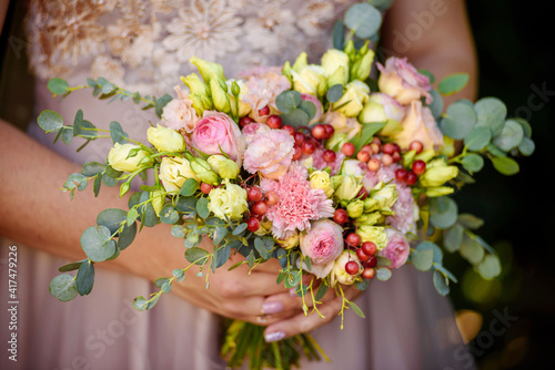 The bride holds a beautiful bouquet in her hands