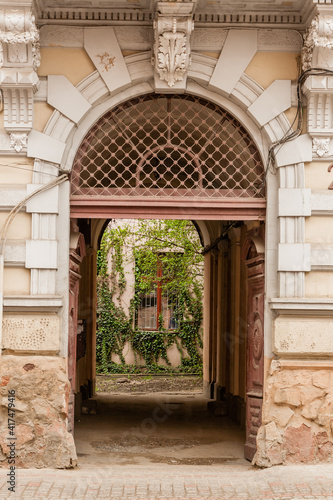 An old gate with a corridor leading to the courtyard of the house