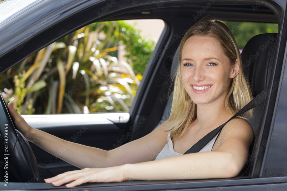 happy woman smiling inside of the car