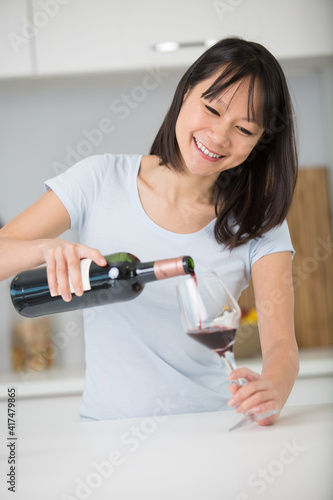 woman serving wine at a party