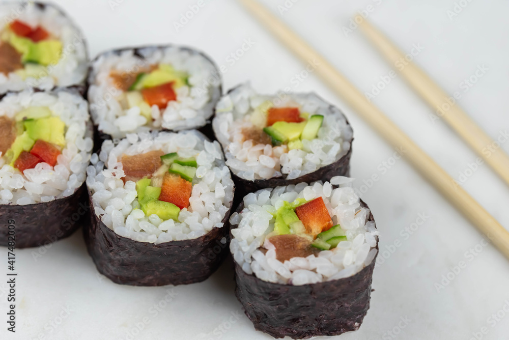 Sushi rolls prepared by professional asian chef with traditional Japanese ingredients. Salmon, rice, vegetables, sesame seeds. Sushi rolls prepared by professional asian chef with traditional Japanese ingredients. Salmon, rice, vegetables, sesame seeds.