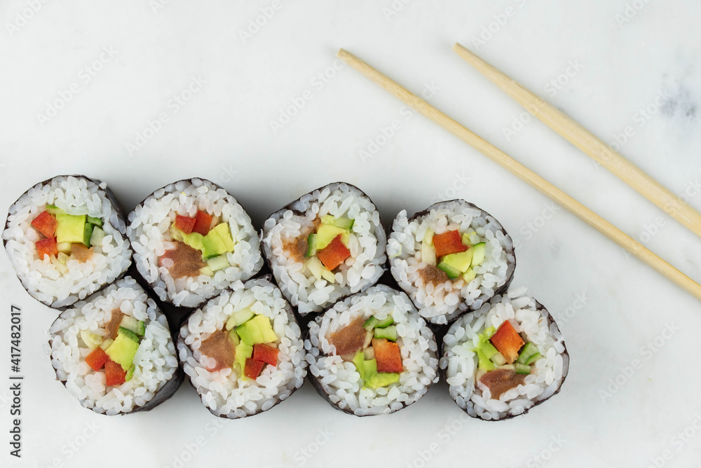 Sushi rolls prepared by professional asian chef with traditional Japanese ingredients. Salmon, rice, vegetables, sesame seeds. Sushi rolls prepared by professional asian chef with traditional Japanese ingredients. Salmon, rice, vegetables, sesame seeds.