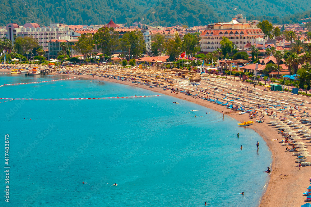 Fototapeta premium Mediterranean coast, beaches of the city of Marmaris. Turkey. Sunny bright day on the beach. Rest and travel to the sea.